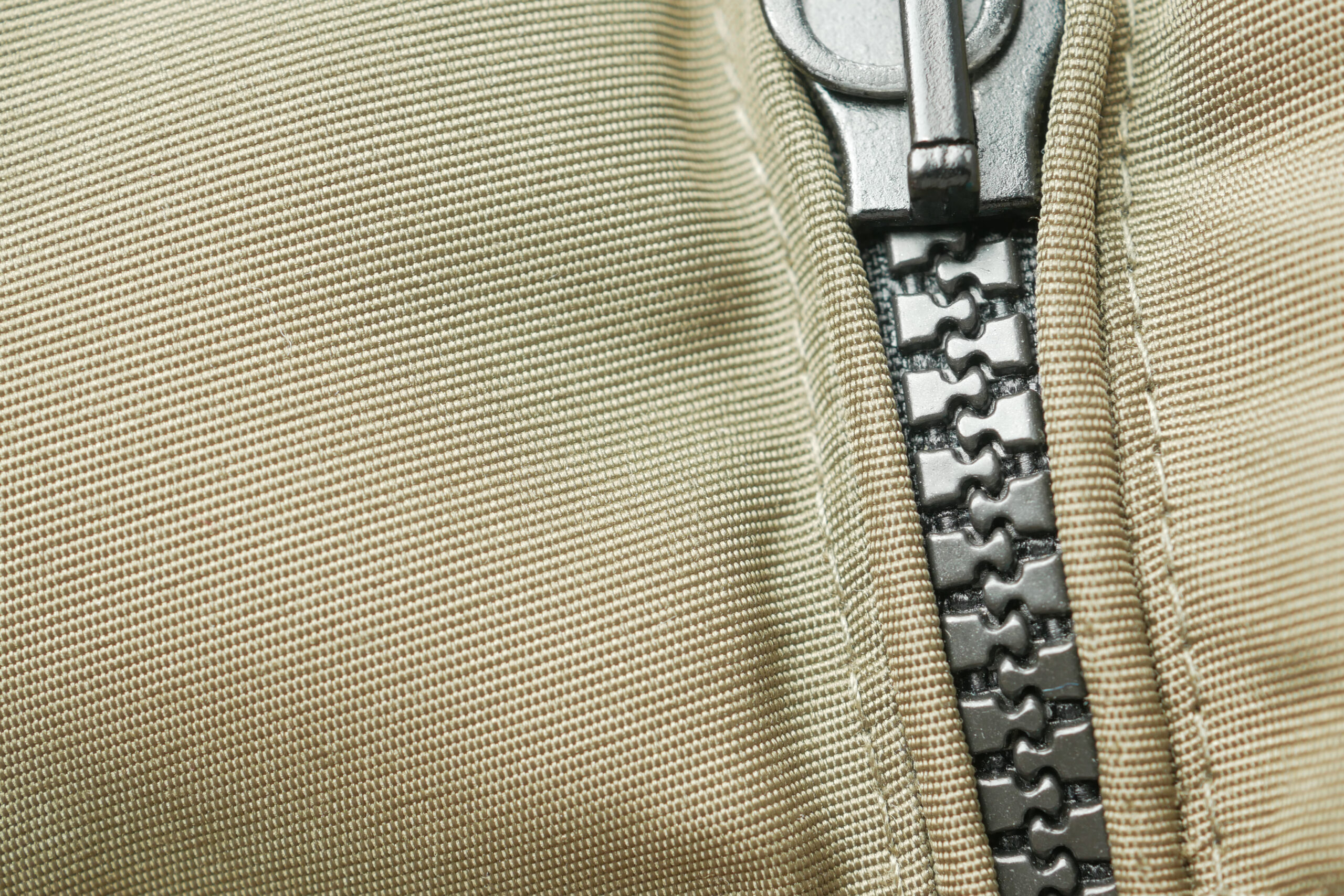 Close-up of a zipper with a slider. molded zipper.