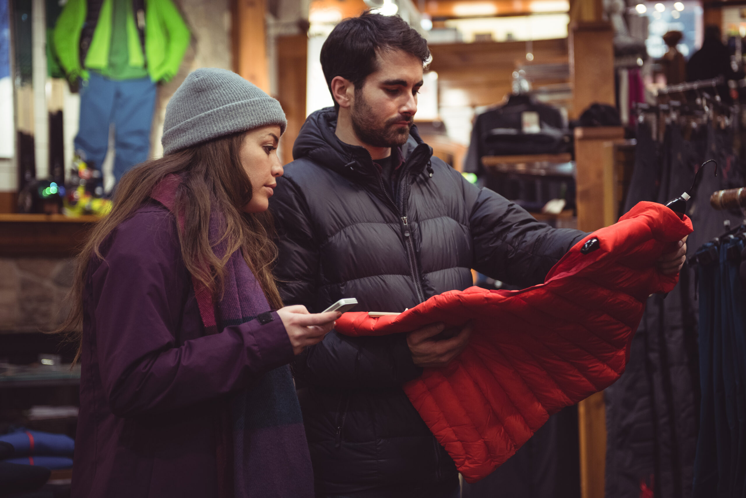 Couple selecting apparel together in a clothes shop