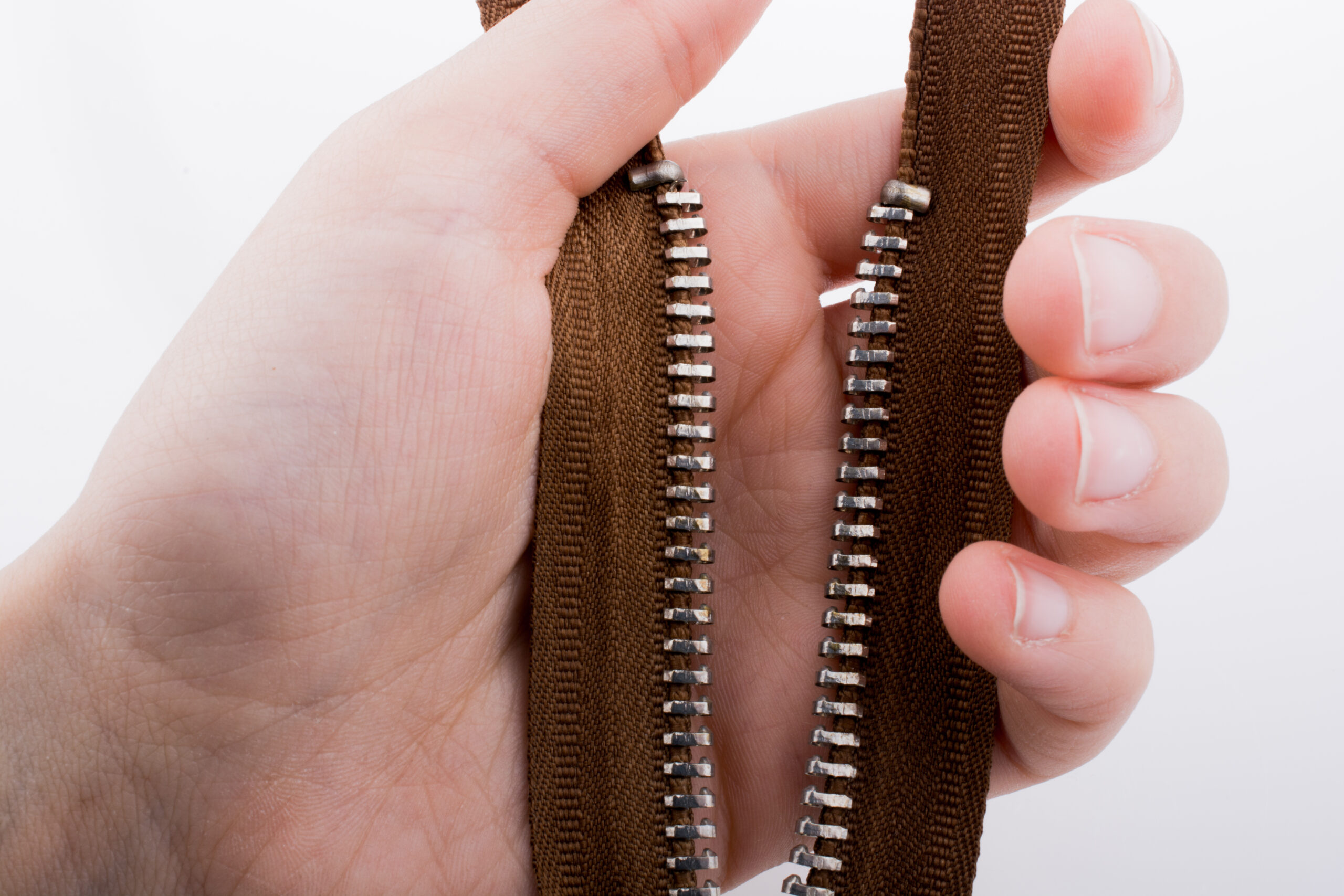 Hand holding broken zipper