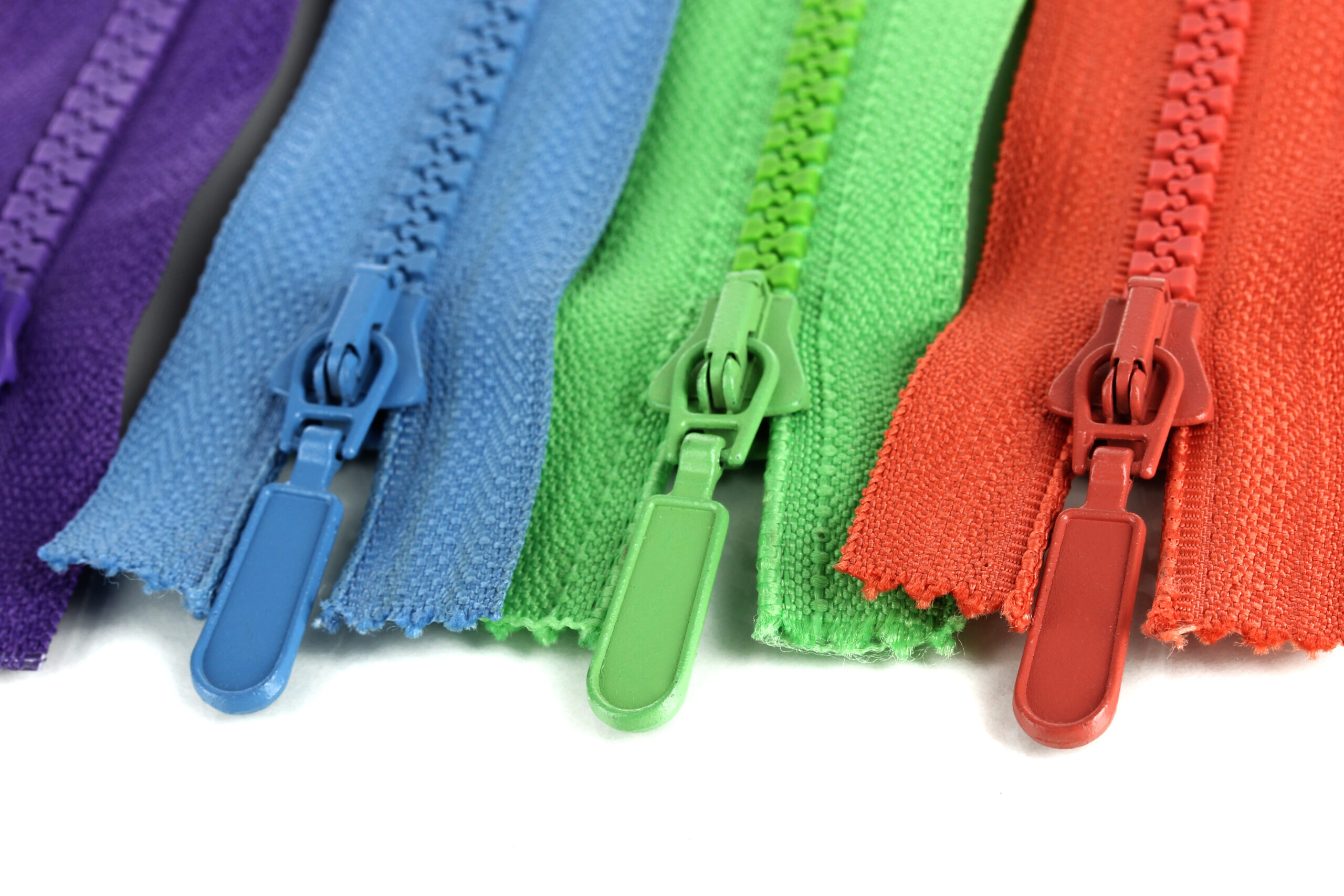 Multicolored zippers isolated on white
